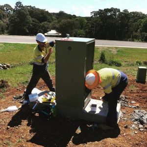 Commercial electricians installing a power box in a street in Byron Bay