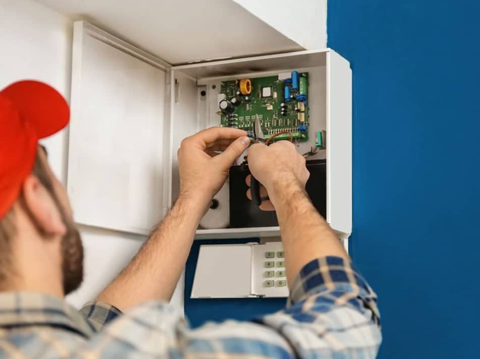 Electrician Installing Alarm System — Coughran Electrical Electrician services in Northern Rivers Byron, NSW